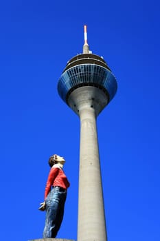Figure looks up at the Rhine Tower