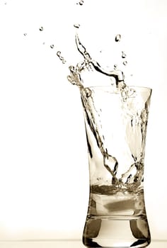 Ice cube falling into water