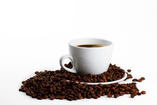 Coffee cup with coffee and beans