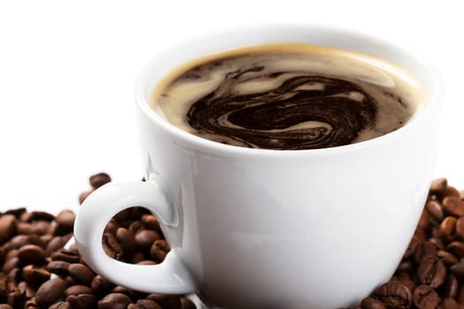 Coffee cup with coffee and beans oblique