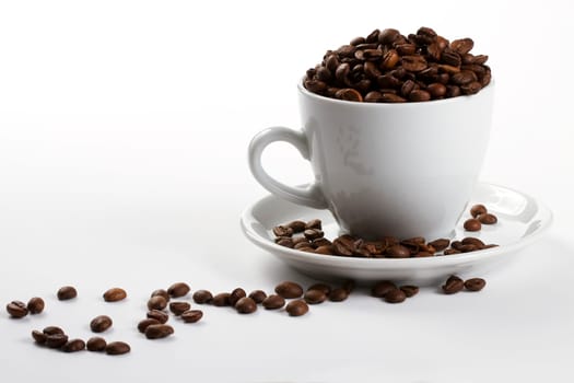 Coffee cup filled with coffee beans