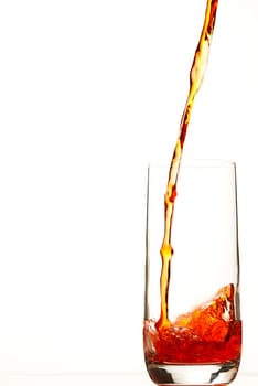 Red liquid flows into glass