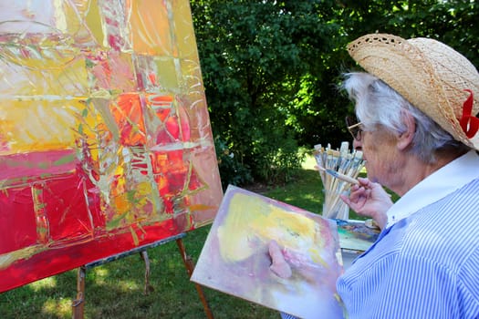 Senior woman painting