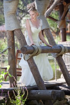 happy bride on wooden bridge