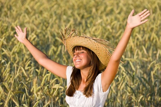 Happy woman enjoy sun in corn field