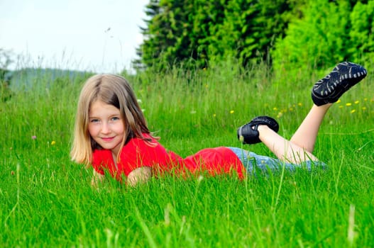 Child lying on meadow