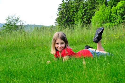 Child lying on meadow