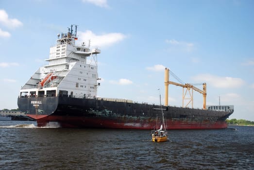 Container ship and sailboat