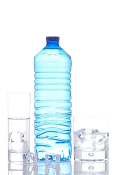 Bottle and glasses of mineral water with ice cubes