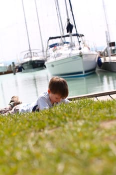 Boy laying before a ship