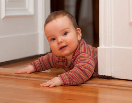 Baby crawls over doorstep