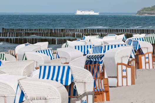 Baltic Sea beach with beach chairs and ferry