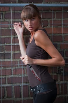 woman with knife at the wall