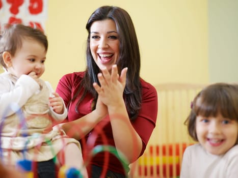 three little girls and female teacher in