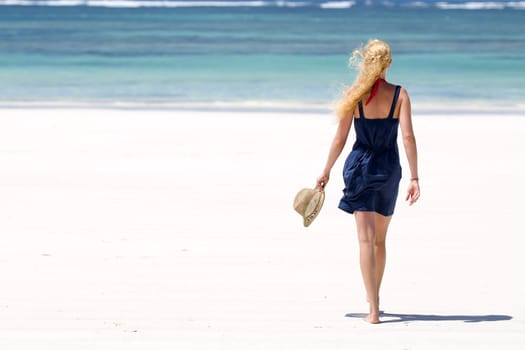 Young woman walking on the beach