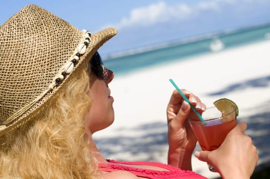 Woman with cocktail on vacation