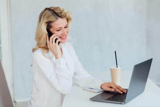 a remote work woman with laptop online communication communication conversation on the phone