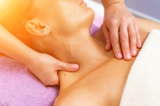 Facial massage. A woman is given a massage in a beauty salon. Close-up.