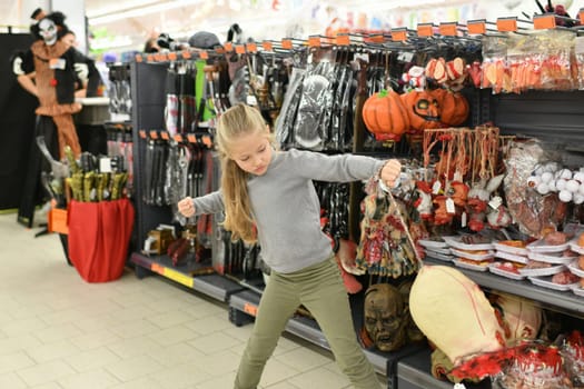 A child looking a costume in a store for Halloween