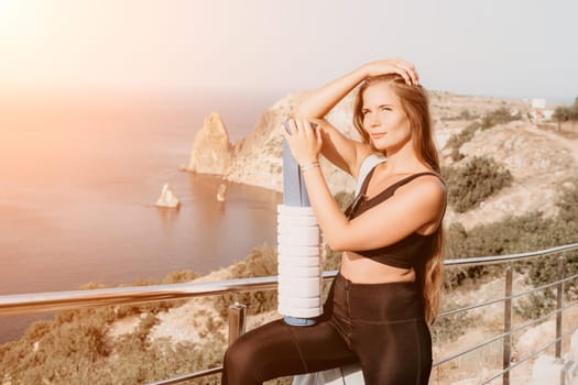 Fitness woman sea. Outdoor workout on yoga mat in park near to ocean beach. Female fitness pilates yoga routine concept. Healthy lifestyle. Happy fit woman exercising with rubber band in park.