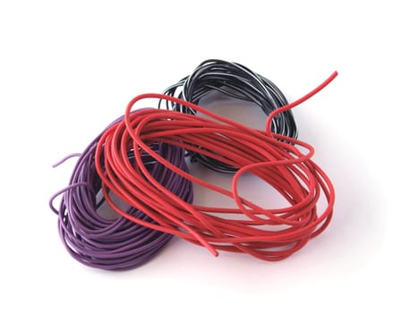 Close up of multicoloured wire on a white back ground.