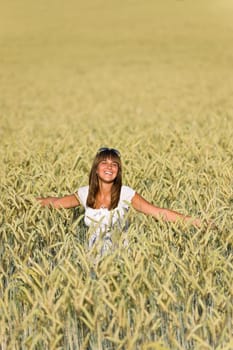 Happy woman in corn field enjoy sunset