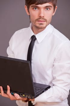 businessman holding laptop computer