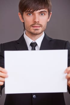 businessman holding blank board