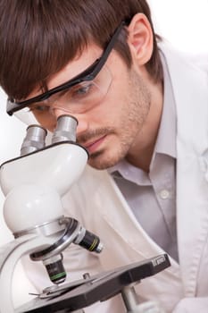 researcher looking in microscope