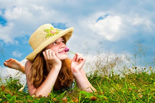 Young girl laying in meadow