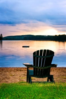 Wooden chair at sunset on beach