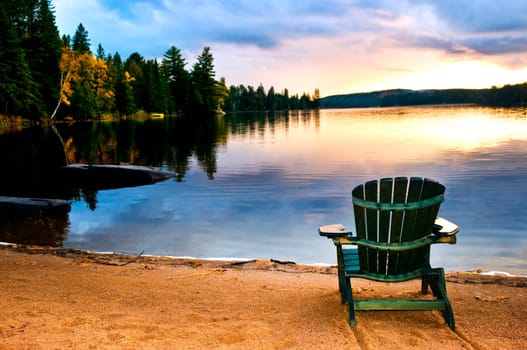 Wooden chair at sunset on beach