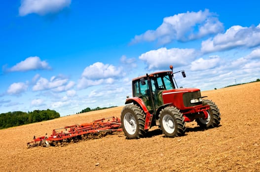 Tractor in plowed field