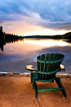 Wooden chair at sunset on beach