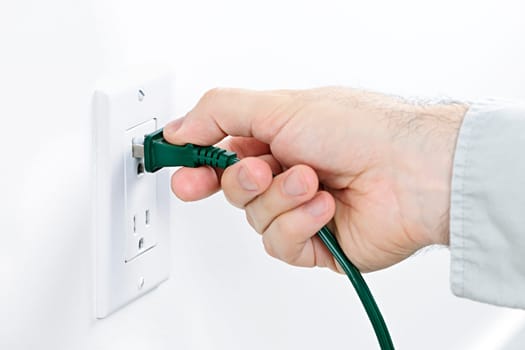 Hand inserting plug into outlet