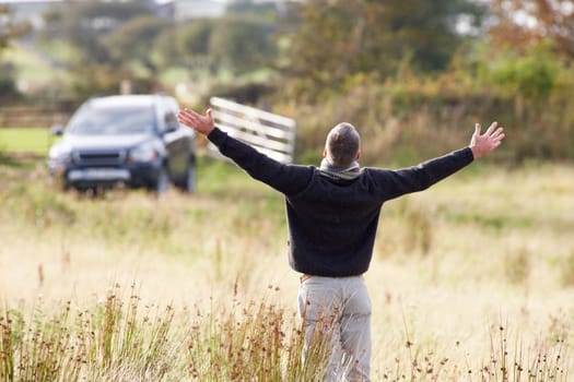 Man Enjoying Freedom Outdoors in Autumn Landscape