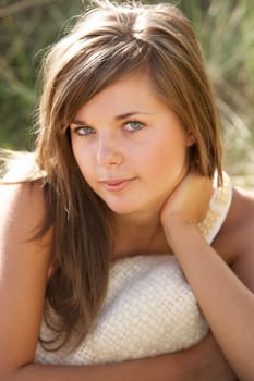 Portrait Of Beautiful Young Woman Relaxing On Beach