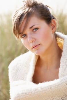 Portrait Of Beautiful Young Woman Relaxing On Beach
