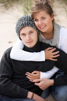 Young Romantic Couple Relaxing On Beach Together