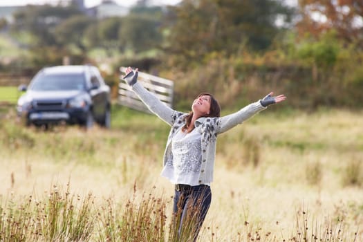 Young Woman Enjoying Freedom Outdoors in Autumn Landscape
