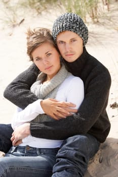 Young Romantic Couple Relaxing On Beach Together