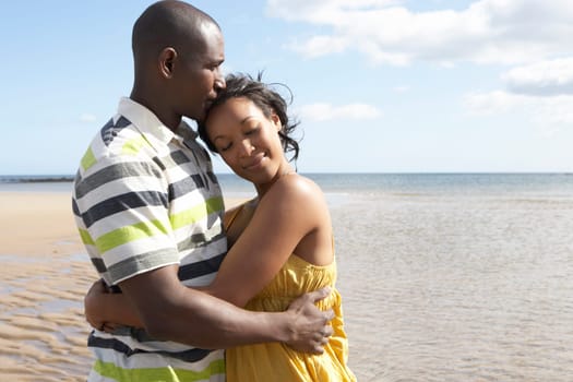 Romantic Young Couple Embracing On Beach