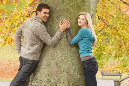 Romantic Teenage Couple By Tree In Autumn Park