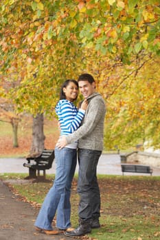 Romantic Teenage Couple In Autumn Park