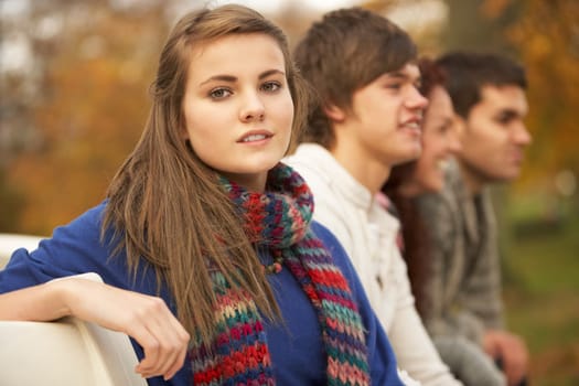 Close Up Of Group Of Teenage Friends In Autumn Park