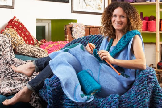 Woman Sitting In Chair Knitting
