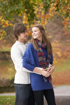 Romantic Teenage Couple In Autumn Park