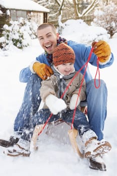 Father And Son Sitting On Sledge