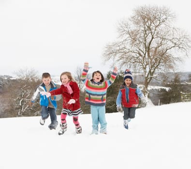 Group Of Children Having Fun In Snowy Countryside