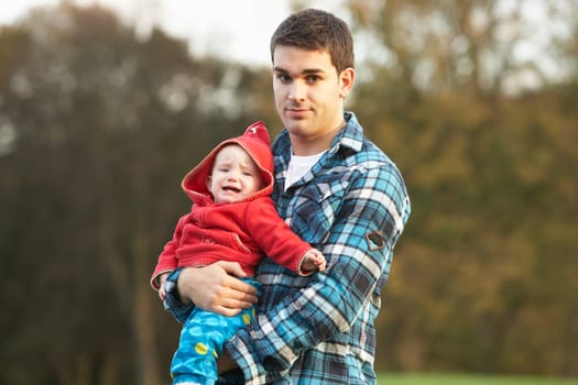Shocked Teenage Boy Holding Baby